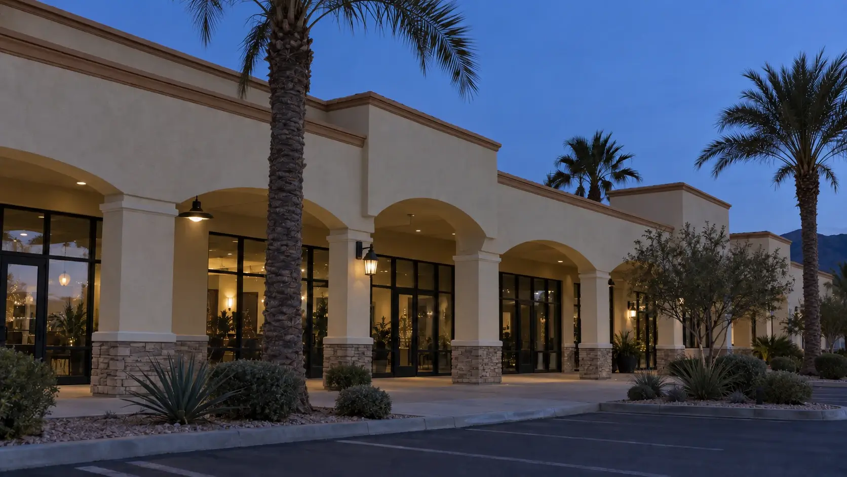 Example of shopping plaza storefronts at dusk with no holiday lighting