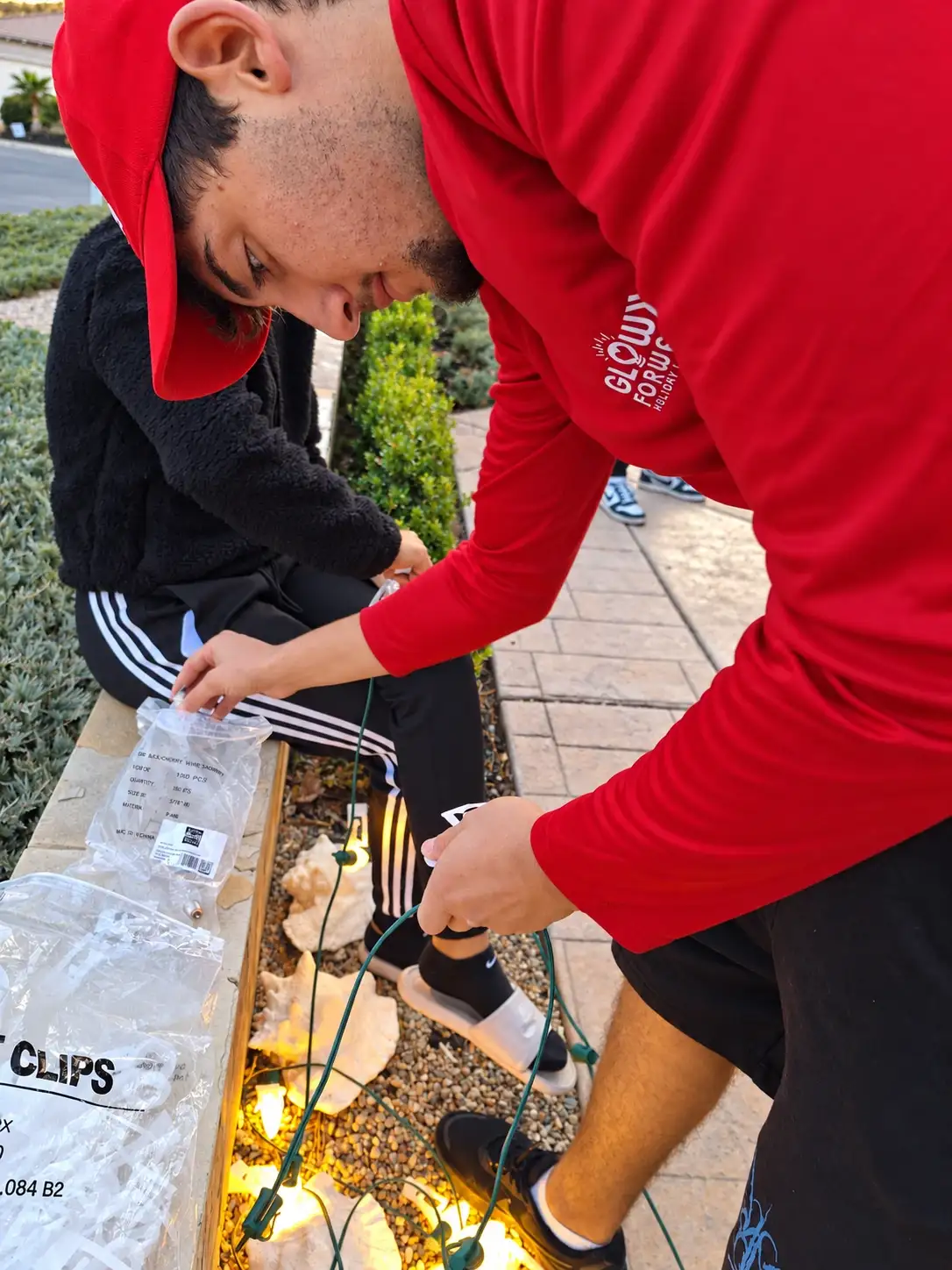 Glow Forward technicians preparing gutter clips and light strands