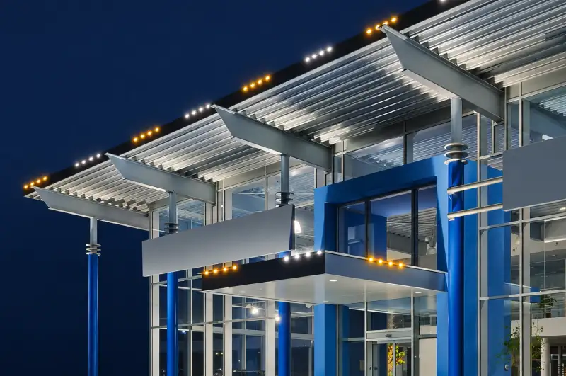 Modern commercial building with permanent roofline lighting in the evening