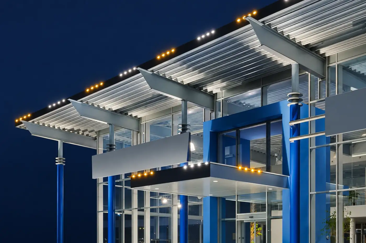 Modern commercial building with permanent roofline lighting in the evening