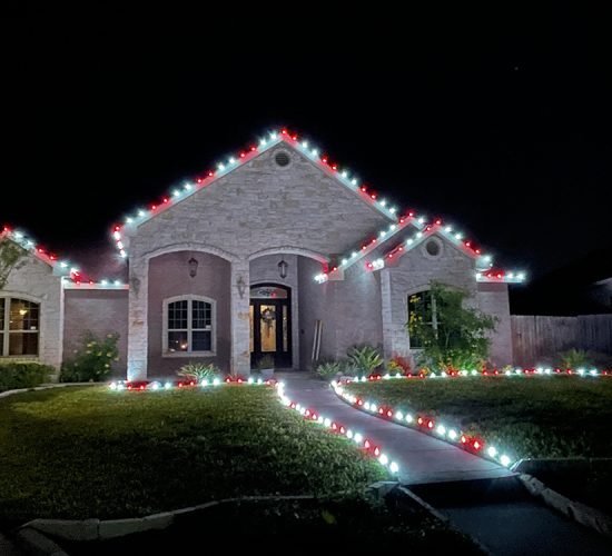 Christmas lights along the roofline of a home in Lehi, Utah Valley, at night
