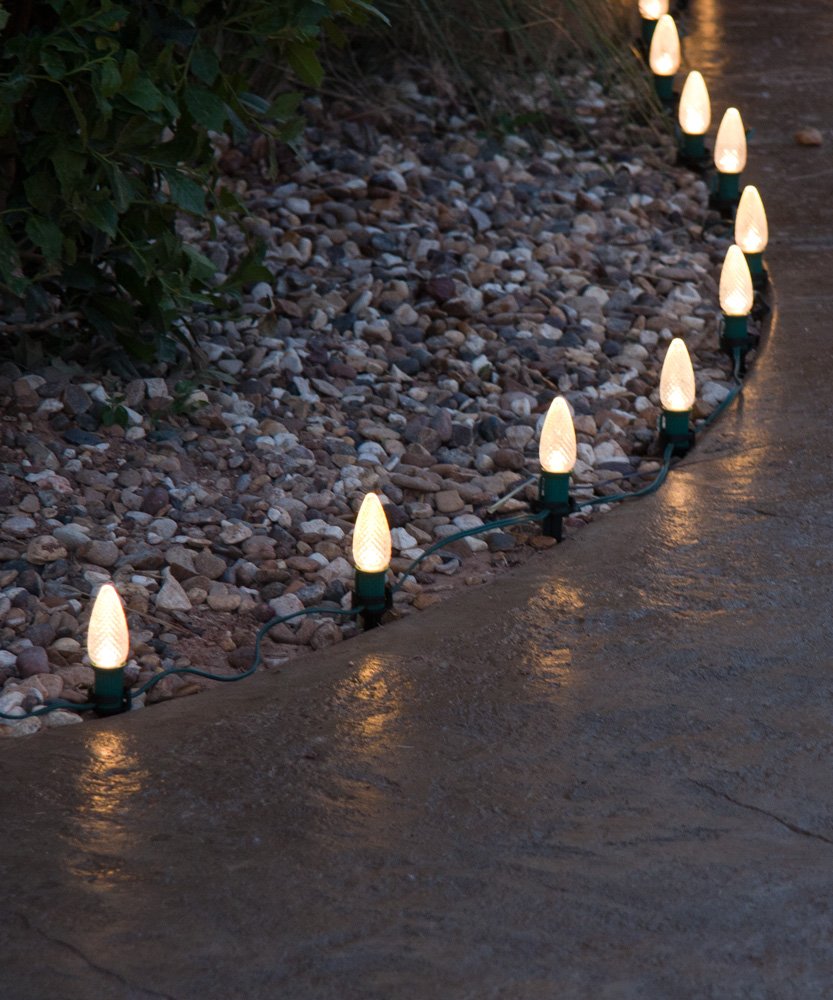 Christmas lights installed on sidewalk line